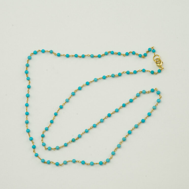 This is a gold and turquoise necklace. The gold is 18kt. The turquoise is from the sleeping beauty mine. It has a lobster claw clasp and is 18" in total length. 