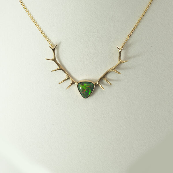 This is the first opal antler pendant we have ever made. The Ethiopian opal has been set in 14kt yellow gold. The chain is 16" in length.