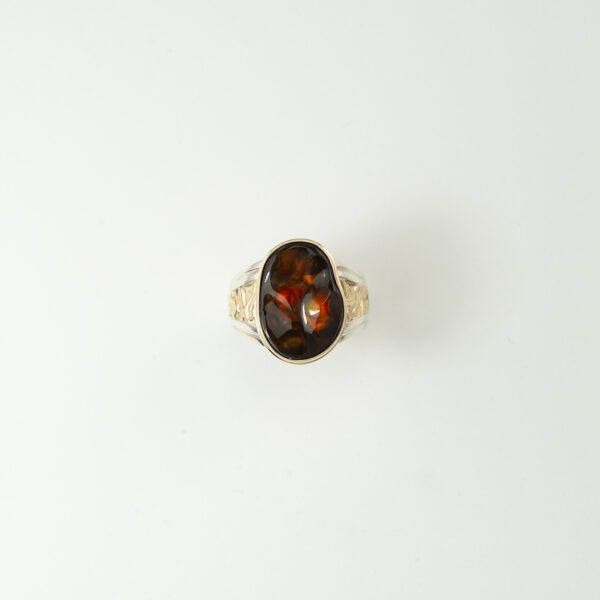 Here is a fire agate men's ring with Silver and Gold. The gold is 14kt and the silver is sterling. Shown in a size 11.5, but can be sized up or down. This ring is hand mande in the United States.