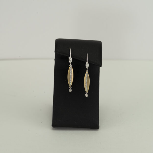 This pair Meira T long earrings has leverbacks. The white and the yellow gold are 14kt and have diamond accents. The yellow gold has a satin finish.