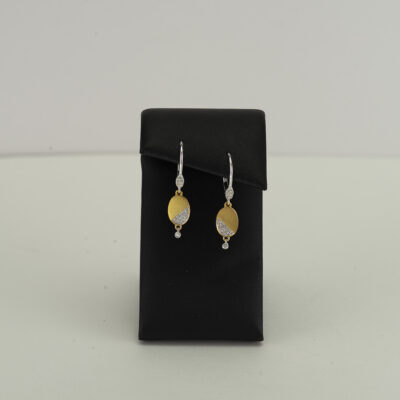 This pair of Meira T small earrings has diamond accents. The diamonds have been set in two tone gold. The gold is 14kt and the earrings are leverbacks.