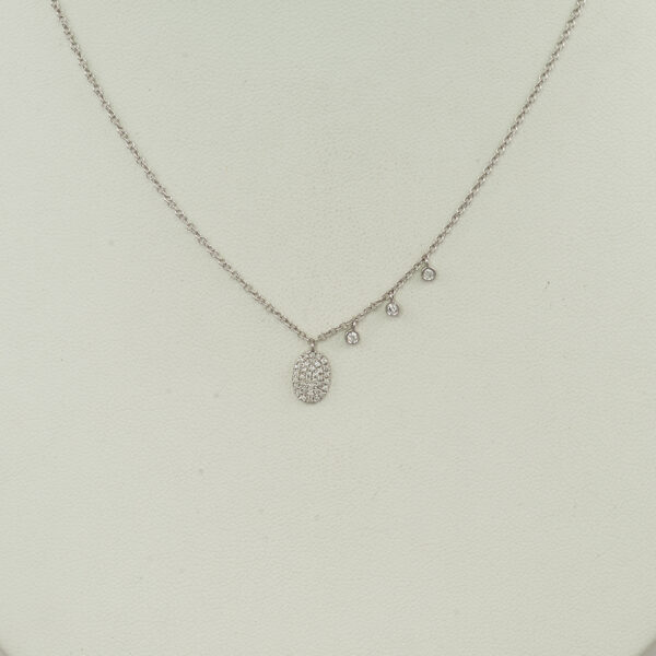 This Meira T oval necklace was made with 14kt white gold. Accenting the oval pendant are three asymmetrical diamond drops. The chain is adjustable in length. 