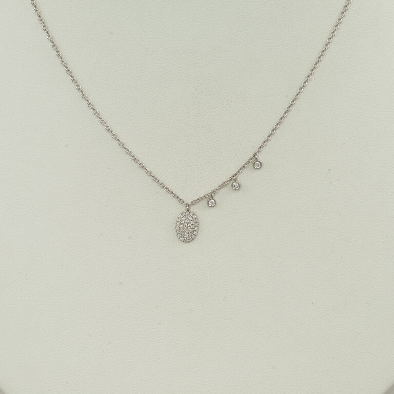 This Meira T oval necklace was made with 14kt white gold. Accenting the oval pendant are three asymmetrical diamond drops. The chain is adjustable in length. 