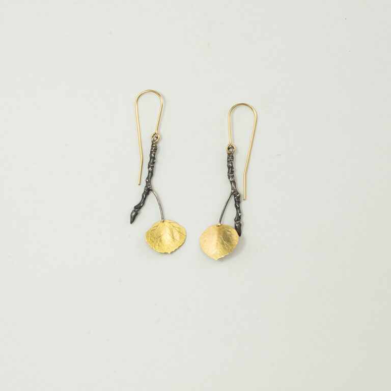 These aspen dangle earrings have French wires. The French wires are 14kt yellow gold. The leaves are 18kt yellow gold. Made by Wolfgang Vaatz.