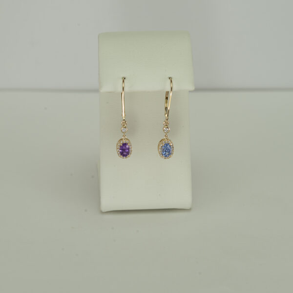 These sapphire earrings have diamond accents. Both the diamonds and the sapphires have been set in 14kt yellow gold. The have been made with leverbacks.