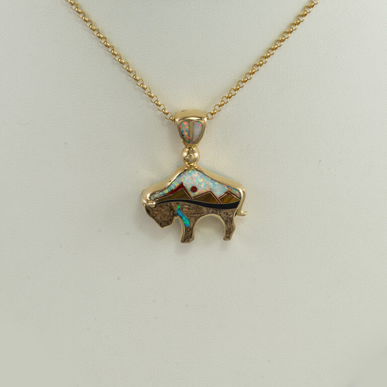 Here is the large inlaid gold bison pendant. WE have  a geometric pattern on one side and a depiction of the Tetons on the other. We offer this pendant in a smaller size. The chain is sold separately.