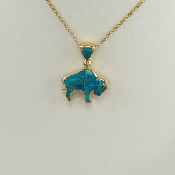 Here is the large inlaid gold bison pendant. WE have  a geometric pattern on one side and a depiction of the Tetons on the other. We offer this pendant in a smaller size. The chain is sold separately.