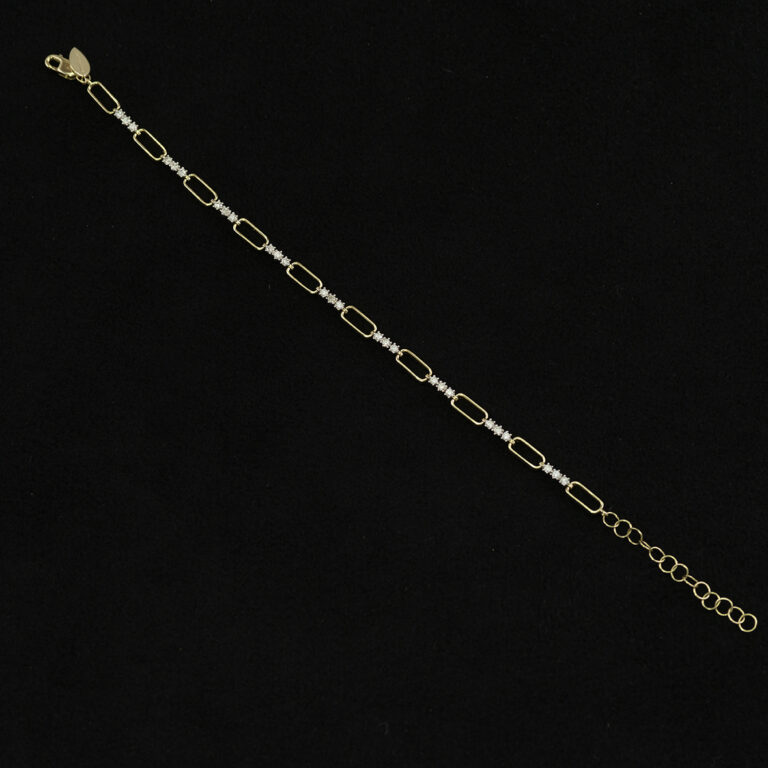 This diamond bracelet was made with 14kt yellow and white gold. The white diamonds have a total carat weight of .45cts. Adjustable in length.