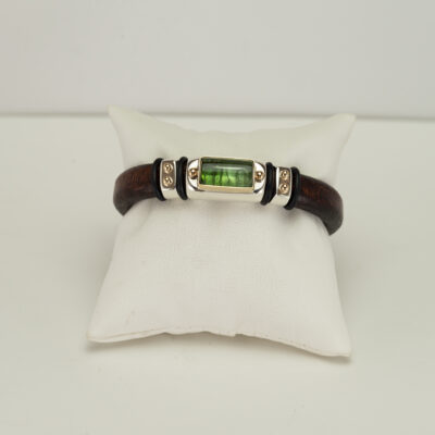 Here is a new green tourmaline bracelet. It has been made with a stainless steel clasp, sterling silver and 14kt yellow gold. The green tourmaline cab is 10cts in weight.