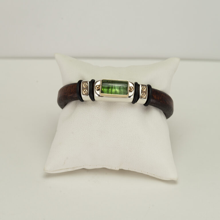 Here is a new green tourmaline bracelet. It has been made with a stainless steel clasp, sterling silver and 14kt yellow gold. The green tourmaline cab is 10cts in weight.