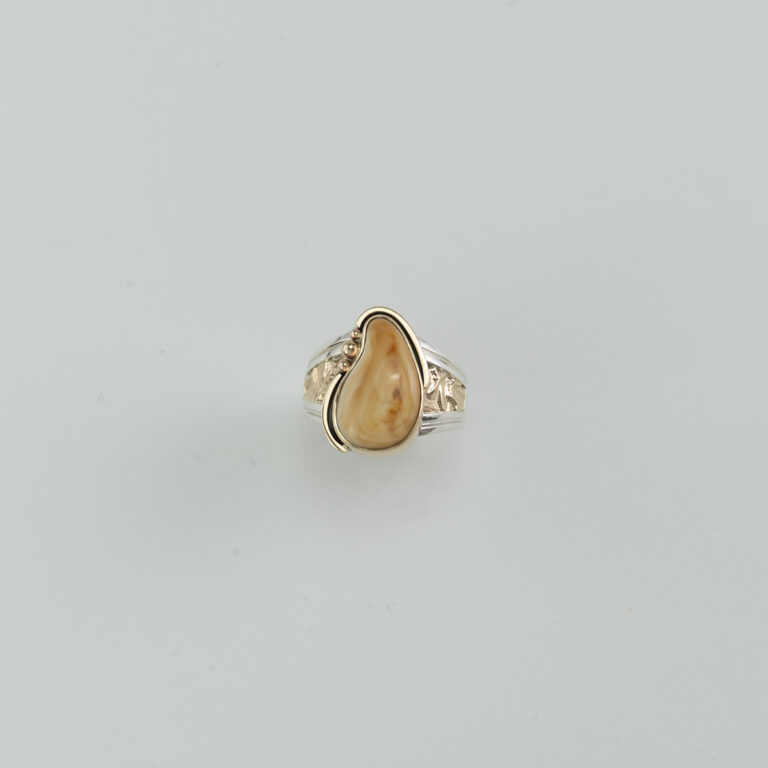 This bull elk ivory ring is one-of-a-kind. The ring was been made with sterling silver and 14kt yellow gold. Shown in a size 11, but can be re-sized.