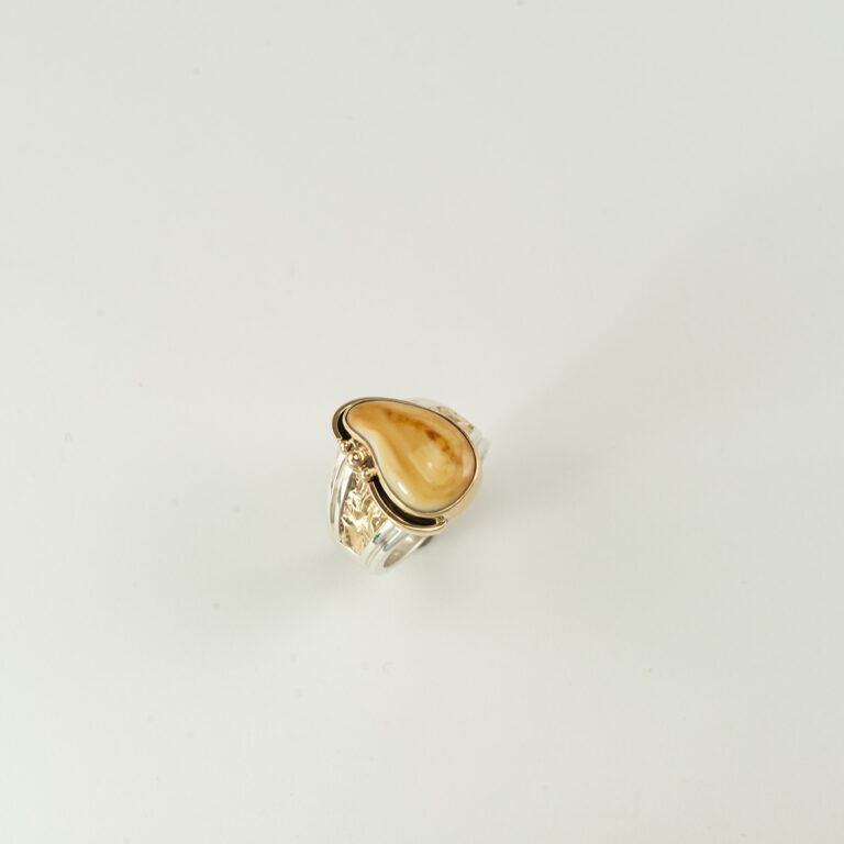 This bull elk ivory ring is one-of-a-kind. The ring was been made with sterling silver and 14kt yellow gold. Shown in a size 11, but can be re-sized.