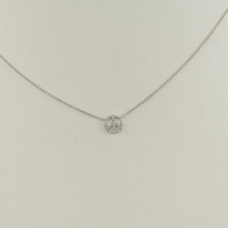 This peace pendant was made using 14kt white gold. Set in the white gold are white diamonds. The diamonds are round cut and the chain is included in the price. It is adjustable in length from 16-18".