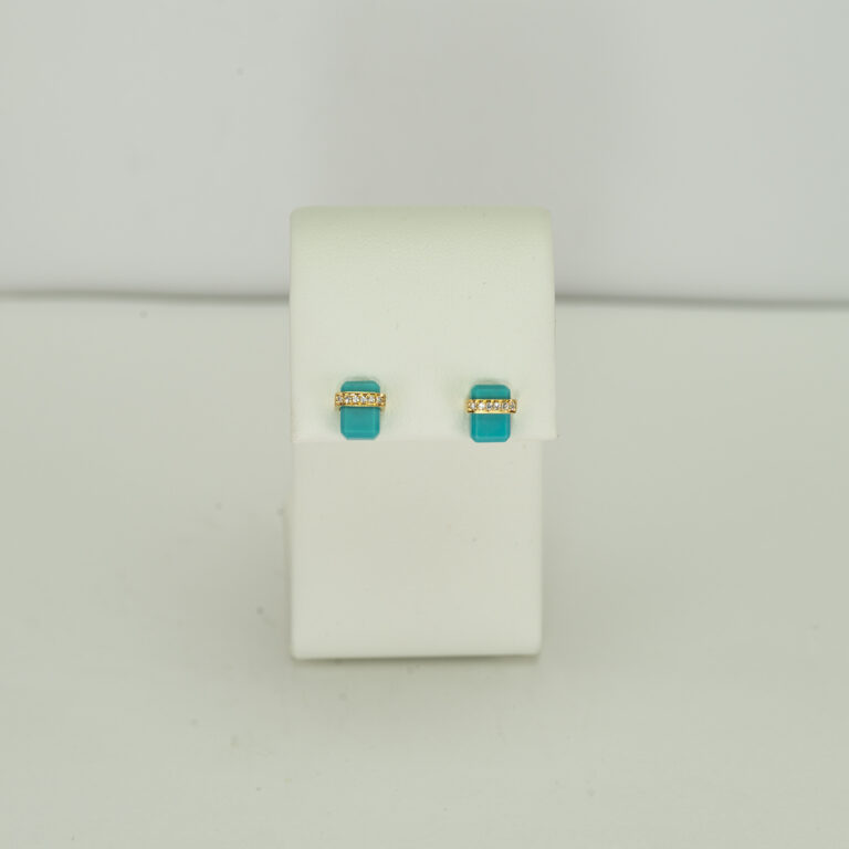 This is a pair of square turquoise studs. They have diamond accents. Both the diamonds and the sleeping beauty turquoise have been set in 14kt yellow gold.