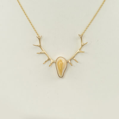 Here is a gold ivory and antler necklace. The gold is 14kt and the chain has lobster claw clasp.  The total length is 18". 