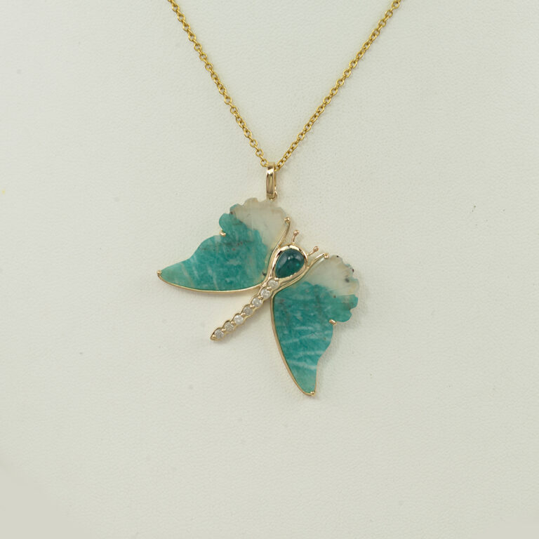 This is a large butterfly pendant with Paraiba tourmaline and milky white diamonds. Both the diamonds and tourmaline has been set in 14kt yellow gold
