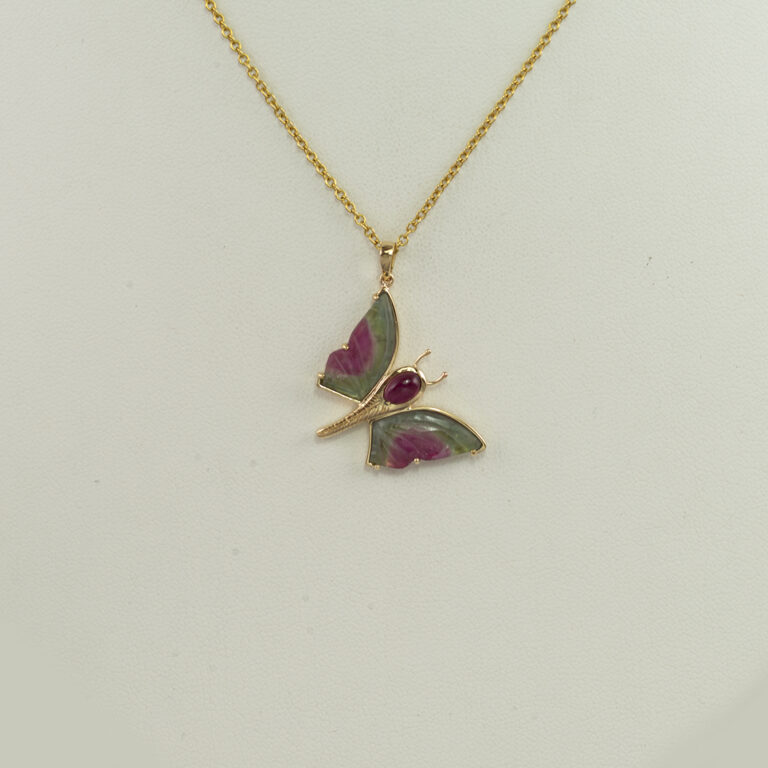 Here is a pink and green butterfly pendant. It has tourmaline wings and a tourmaline cabochon. The entire piece has been made with 14kt yellow gold. The chain is sold separately. 