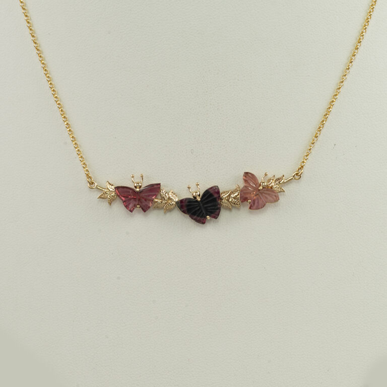 This triple butterfly necklace is a one-of-a-kind. It was made with 14kt yellow gold, carved tourmaline and the chain is included in the price. 
