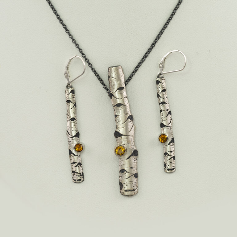 This is the aspen jewelry collection. The necklace and earrings can be purchased as a set or independently. Both pieces feature citrine gemstones.