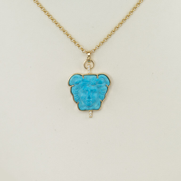 This is an amazing carved turquoise pendant. The turquoise was carved in Italy and depicts a roman face. Accenting the turquoise are white diamonds. Both the diamonds and the Turquoise have been set in 14kt yellow gold. The chain is not included in the price. 