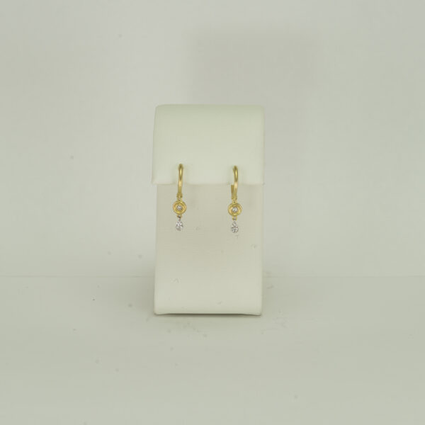 Here is a pair of small gold earrings by Meira T. They were made with 14kt white gold, 14kt yellow gold and diamonds. The diamonds are brilliant-cut.