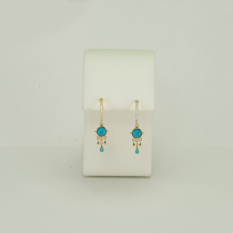 This pair of diamond and turquoise earrings was designed by Meira T. The turquoise and the diamonds have been set in 14kt yellow gold.