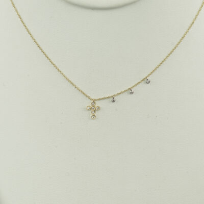 This yellow gold cross was designed by Meira T. The gold is 14kt and the diamonds are round cut. The chain's length can be adjusted.