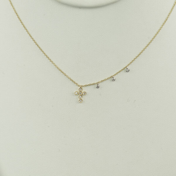 This yellow gold cross was designed by Meira T. The gold is 14kt and the diamonds are round cut. The chain's length can be adjusted.