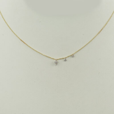 This tiny cross necklace was made by Meira T. The diamonds are set in 14kt white gold. The chain is 14kt yellow gold and the chain is adjustable in length.