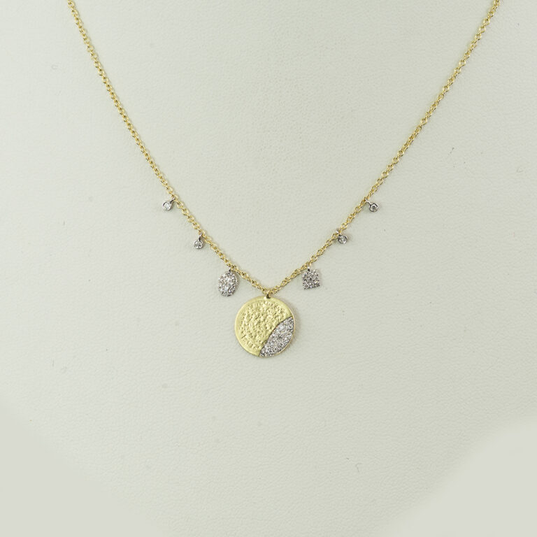 This disc necklace by Meira T was made with both 14kt yellow and white gold. The gold has been paved with diamonds. The chain is adjustable in length.