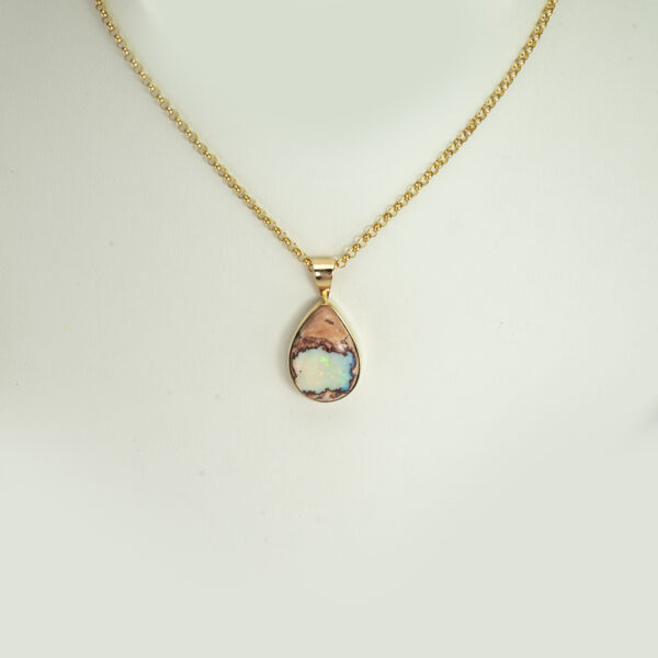 This is a one-of-a-kind matrix opal pendant. The matrix opal has been set in 14kt yellow gold. The bail is large enough to accommodate a variety of chains.