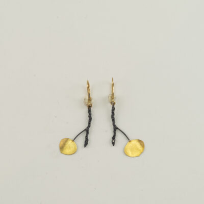 These aspen leaf earrings were made by Wolfgang Vaatz. They are sterling silver with 18kt gold. We also have pendants to match.