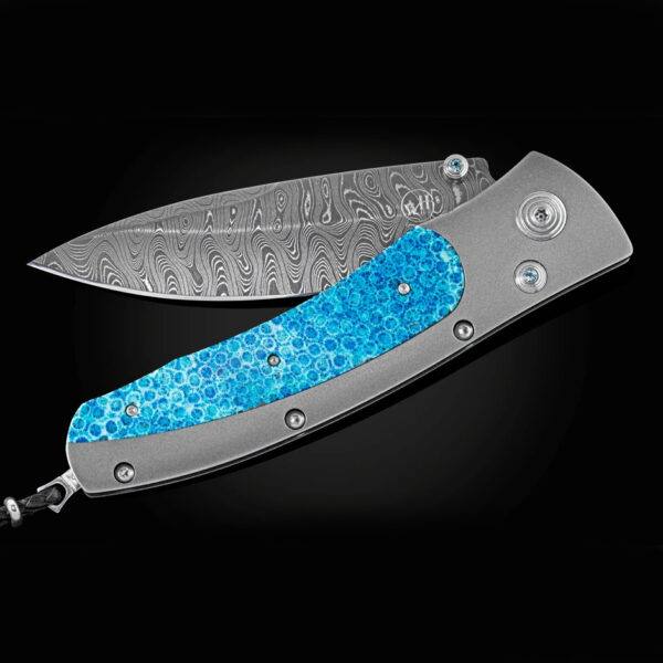 This is the blue coral knife by william henry. It has aerospace grade titanium, blue corral, ripple damascus and blue topaz gemstones.