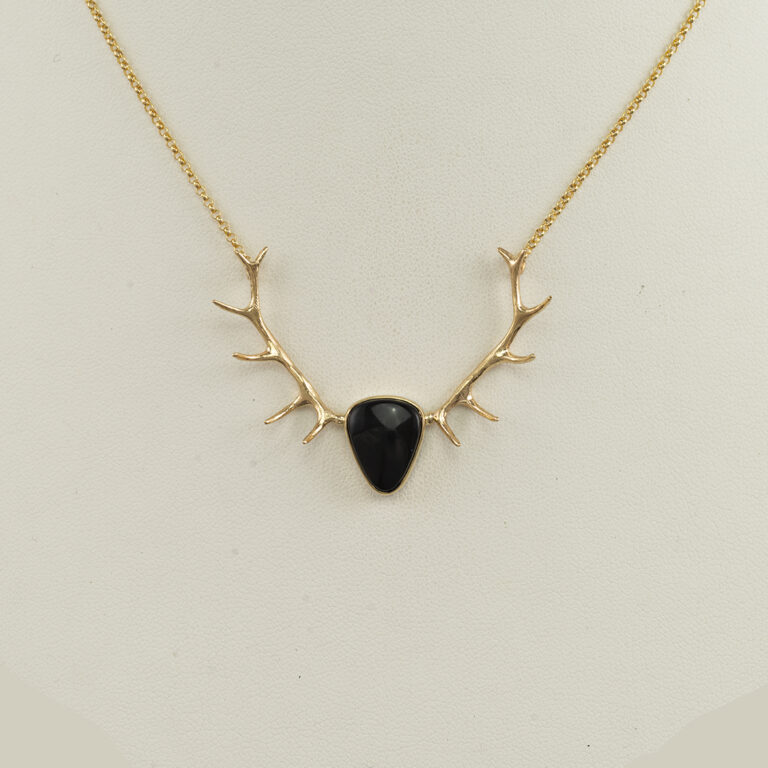 This black jade and antler pendant is one-of-a-kind. The gold is 14kt and the backplate is sterling silver. The total length is 18".