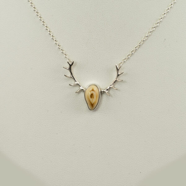 This is a silver elk ivory pendant with antlers. The chain is 16" in length but fits more like a 17" length. The chain has a lobster claw clasp.