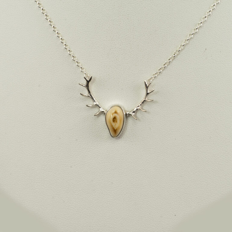 This is a silver elk ivory pendant with antlers. The chain is 16" in length but fits more like a 17" length. The chain has a lobster claw clasp.