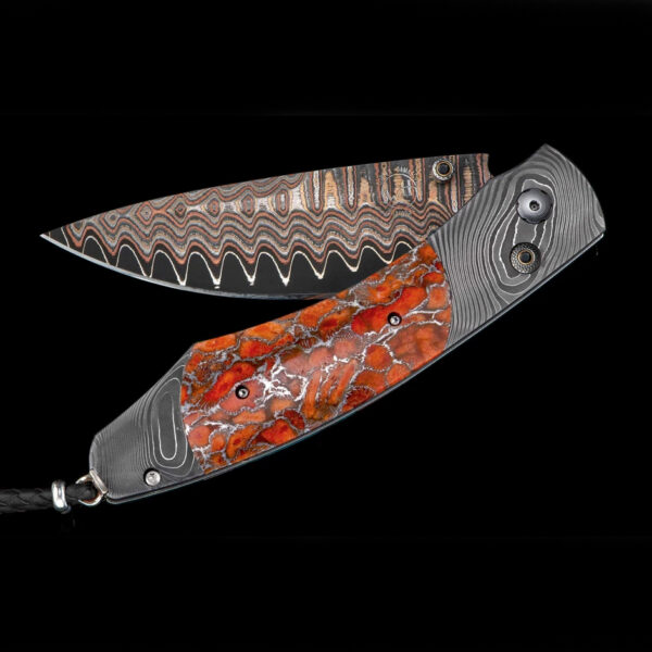The Spearpoint ‘Liquid Sky’ features a frame in hand-forged 'Twist' damascus by Chad Nichols, inlaid with Zinc Matrix apple coral.