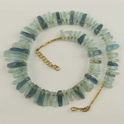 This aquamarine necklace is one-of-a-kind. Accenting the aquamarine are 14kt yellow gold plated beads. The total length is 20".