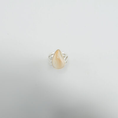 This women's elk ivory ring was made with sterling silver and 14kt yellow gold. The bezel is 14kt yellow gold and the ring shank is sterling silver.