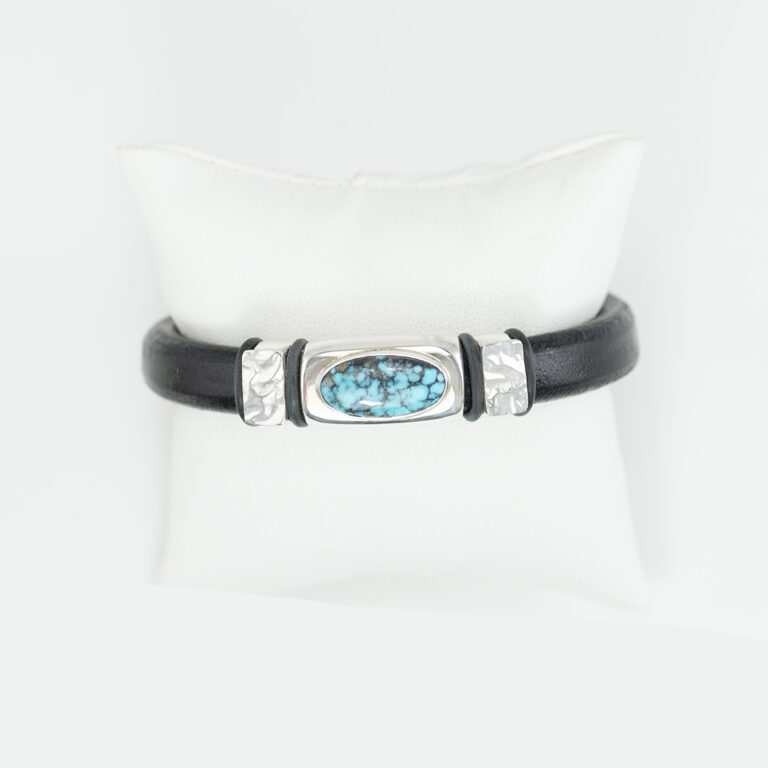 This Turquoise and leather bracelet was made with sterling silver, 14kt yellow gold and hubei turquoise. The clasp is a magnetic stainless steel.