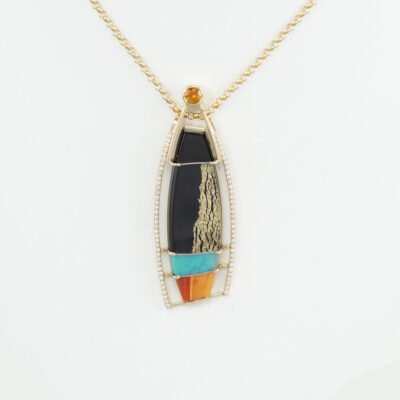 This is a one of a kind pendant by Dan Harrison. It features a collage of black jade, 24kt gold leaf, spiny oyster shell, Chrysocolla on Mother of Pearl.