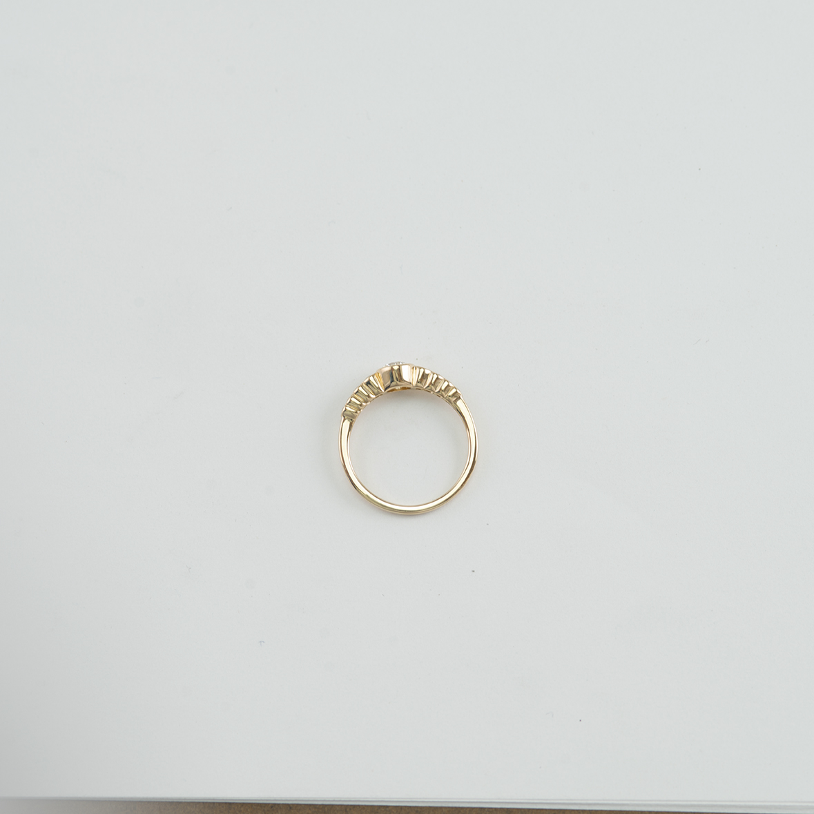 This white diamond ring has been set in 14kt yellow gold.